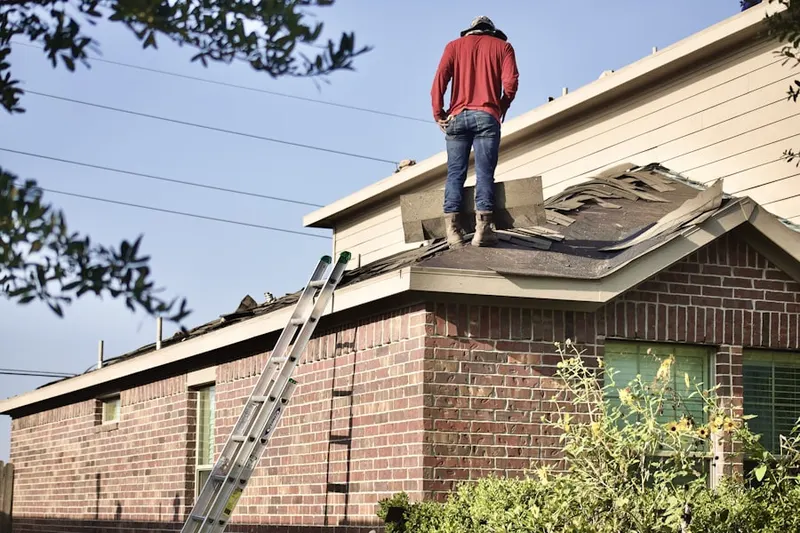Professional roofer working on a residential roof in Elmwood Park